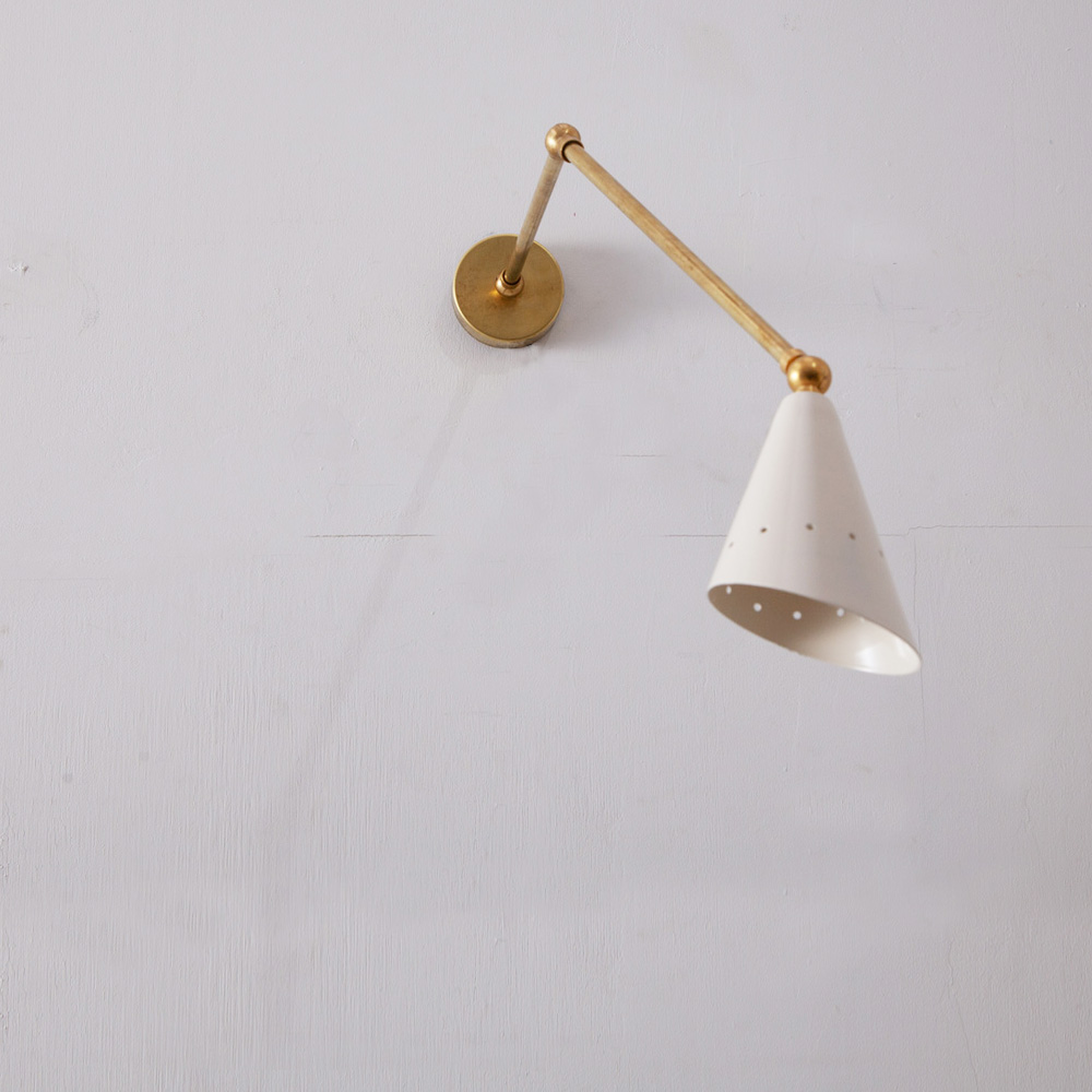 white and brass wall light