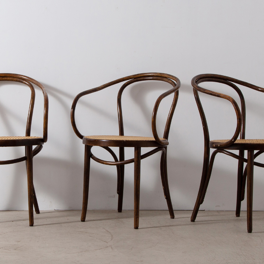 B9 / 209 Arm Chair for THONET , ZPM RADOMSKO in Wood , Rattan and Brown
Poland , 1940s
THONET（トーネット）社より、ヴィンテージの209アームチェア。
別名「コルビュジエ・チェア」としても良く知られるこの椅子は、建築家のル・コルビュジエが愛用し、1925年にパリで開催された「現代装飾・産業美術国際博覧会」のエスプリ・ヌーヴォー館、1927年ヴァイセンホーフ・ジードルンク住宅などで採用されています。
事務用の椅子として開発されたチェア、トーネット社のB9（後のNo209）はエレガントでクラッシックな佇まいが魅力の曲げ木椅子の名作です。デスクチェア、ダイニングやベットルームなどのプライベートなスペースなど場所を選ばずご使用頂けます。 
今回入荷したこちらの3脚は、トーネットの工場で第二次世界大戦後に旧ポーランドで国有化された「ZPM RADOMSKO」にて製造された個体です。
