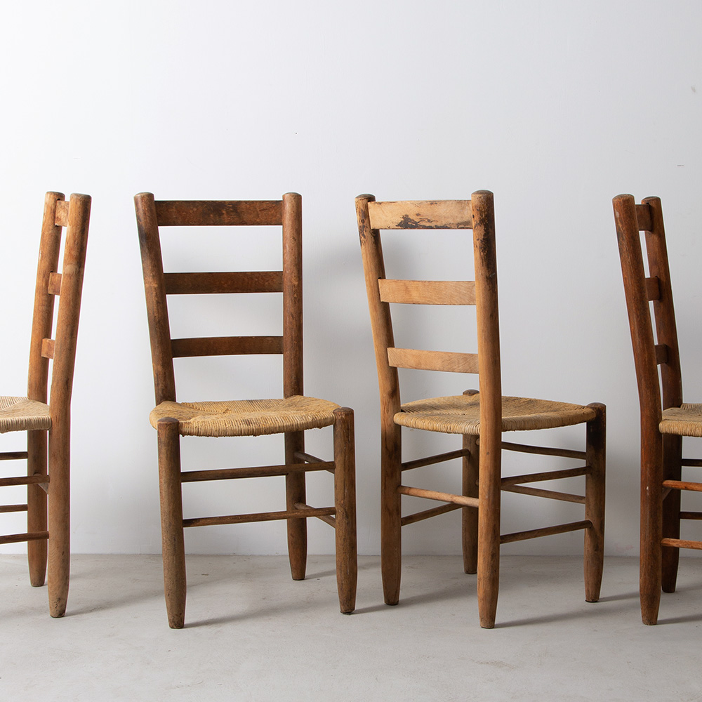 Rush Chairs Attribute to Charlotte Perriand for Sentou in Beech
France , 1950s
Charlotte Perriand（シャルロット・ペリアン）のモデル No 19 が製造されていた Sentou（セントー）社にて製造されたダイニングチェア。
正面から見ると背中か真っ直ぐに伸びた、シェーカーチェアに近いフォルムに見えますが、背は若干傾斜がつけられており、後部へ重心がかかり過ぎることのない絶妙なデザインとなっています。 
同デザイン6脚入荷しています。
Sentou社 は1947年、戦後のフランスで Robert Sentou がモーザック刑務所の囚人を更生させるプロジェクトの一環として、フランス南西部に最初の工房「La Chaise Paillée」を設立したことから始まり、当時世界で流行していた、藁編みが使用されたチェアの本格的なノウハウを培いました。
その後は若いデザイナーのためにギャラリーを企画したり、経営権を譲るなど、柔軟な姿勢で家具デザインと会社の発展に努めました。
